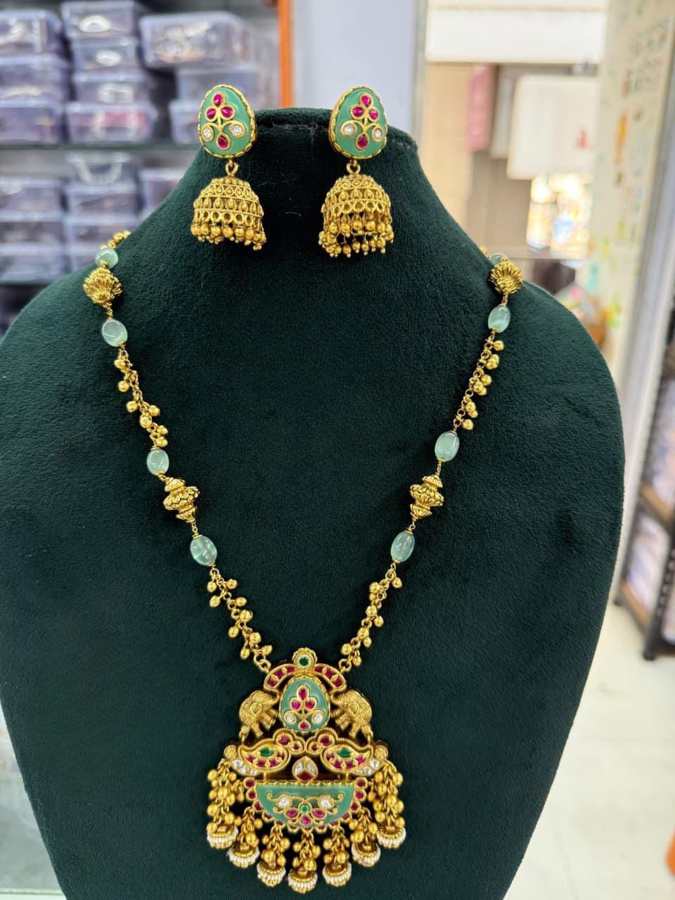 Antique Gold Finish Kundan Pendant Necklace Set with Jhumka Earrings – Green & Ruby Enamel