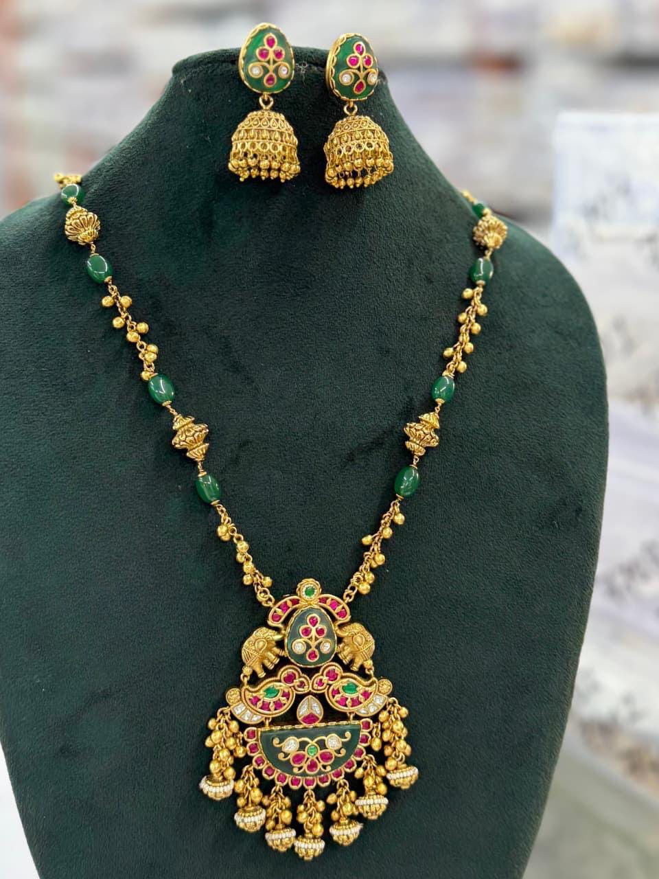 Antique Gold Finish Kundan Pendant Necklace Set with Jhumka Earrings – Green & Ruby Enamel